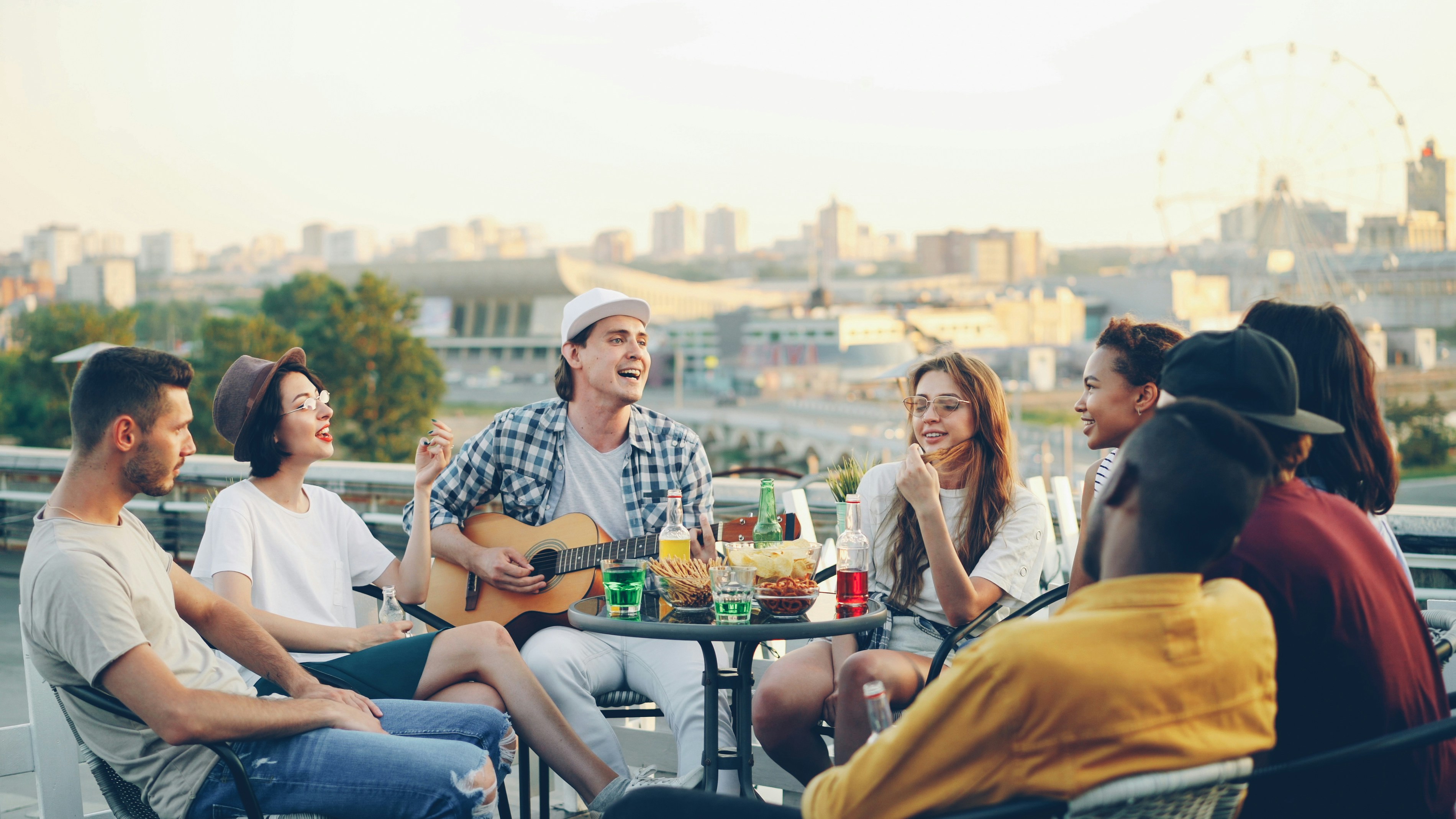 Joyful male musician playing guitar with friends