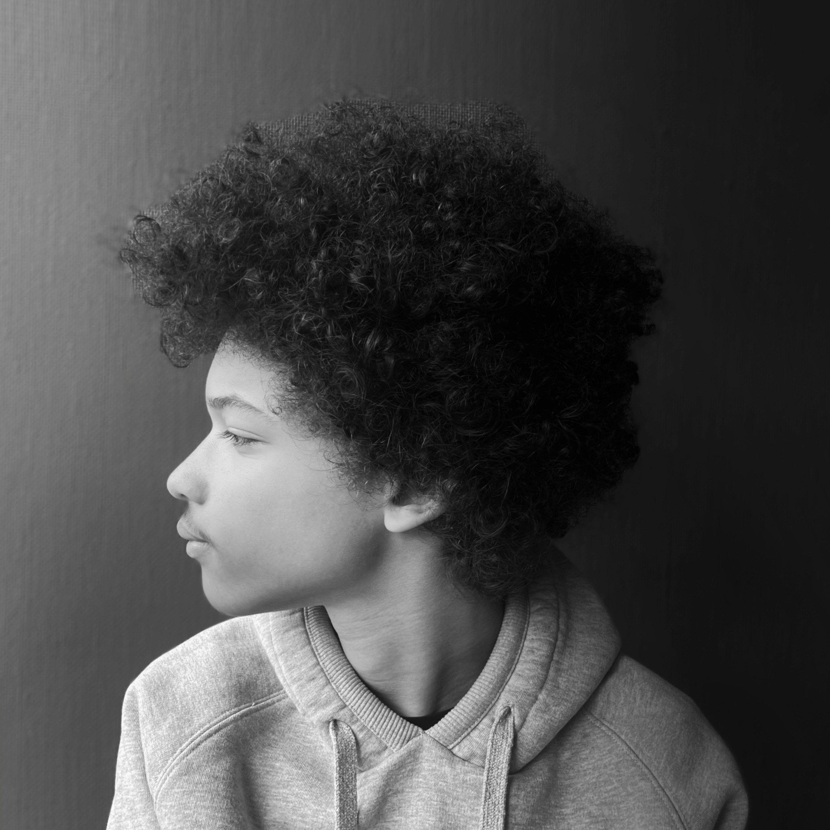 Young person with afro hair in profile