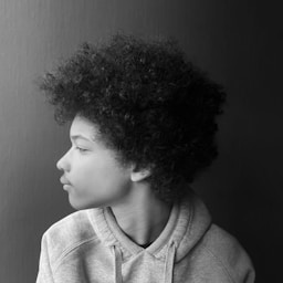 Young person with afro hair in profile