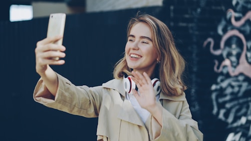 Young woman taking a selfie with headphones