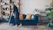 Woman cleaning the floor in a modern living room.