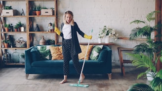Woman dancing while mopping the floor