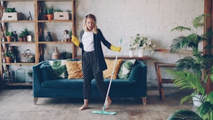 Woman dancing while mopping the floor