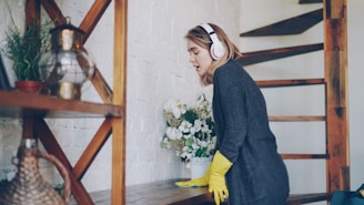Woman cleaning while listening to music on headphones
