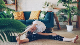 Woman stretching on floor in a living room.