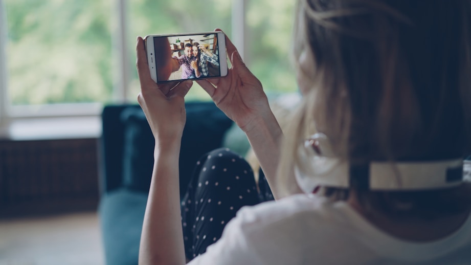 Woman watching video on smartphone indoors