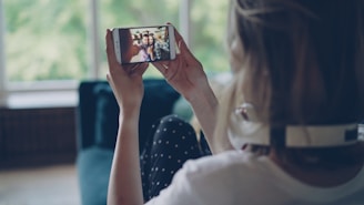 Woman watching video on smartphone indoors