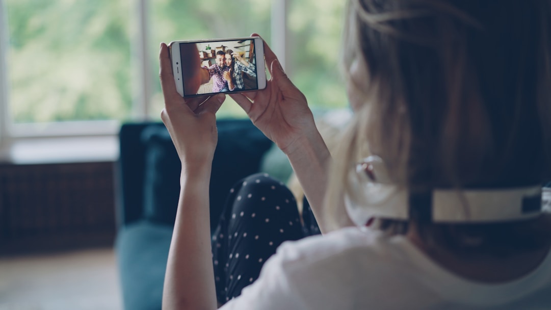Woman watching video on smartphone indoors
