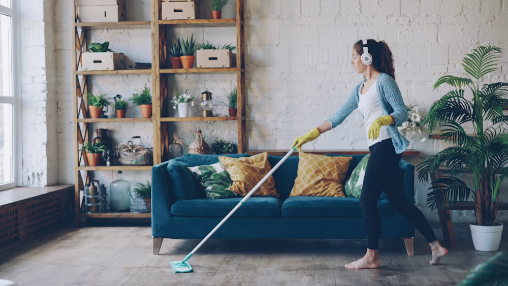 A cleaner mopping a wooden floor