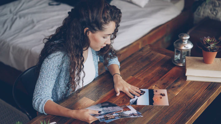 Woman looking at photographs on a table