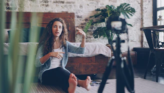 Woman recording a video in a stylish room.