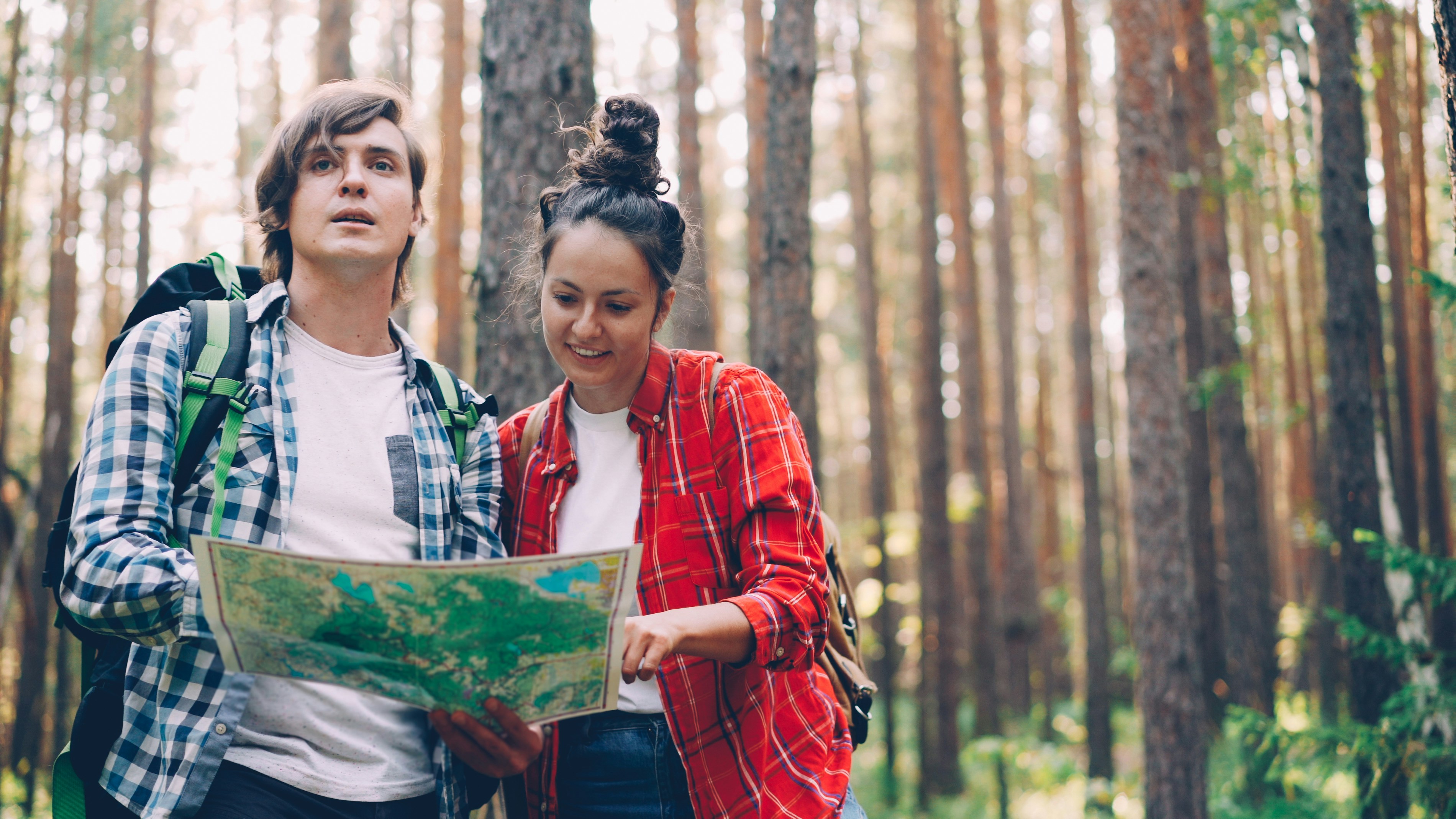 couple looking at a map - romantic getaways for couples