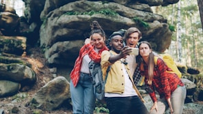 Four friends taking a selfie in a rocky forest