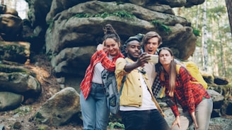 Four friends taking a selfie in a rocky forest