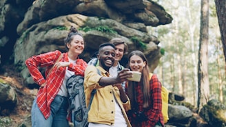 Four friends taking a selfie in a forest