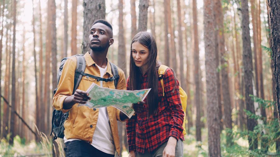Two hikers reading a trail map together, one looking ahead to where they are going