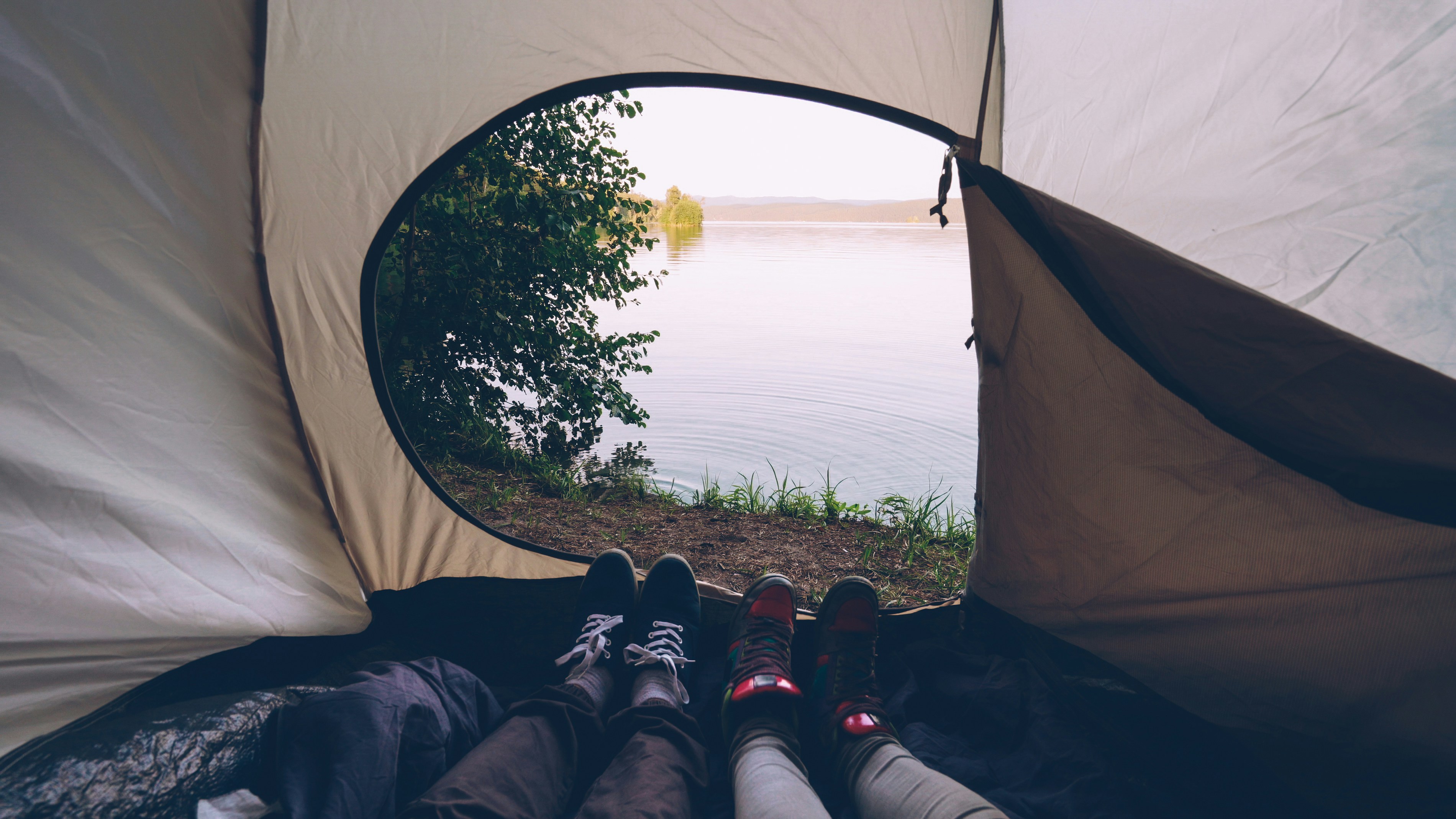 View of a lake from inside a tent