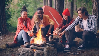 Friends roasting marshmallows around a campfire at night.