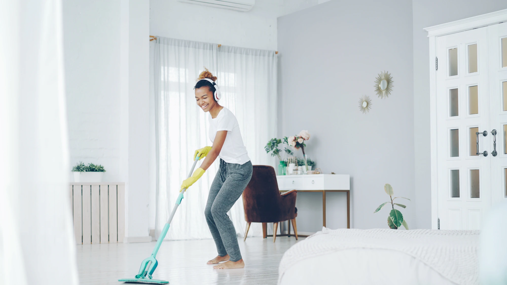 Mopping the floor of a bright room