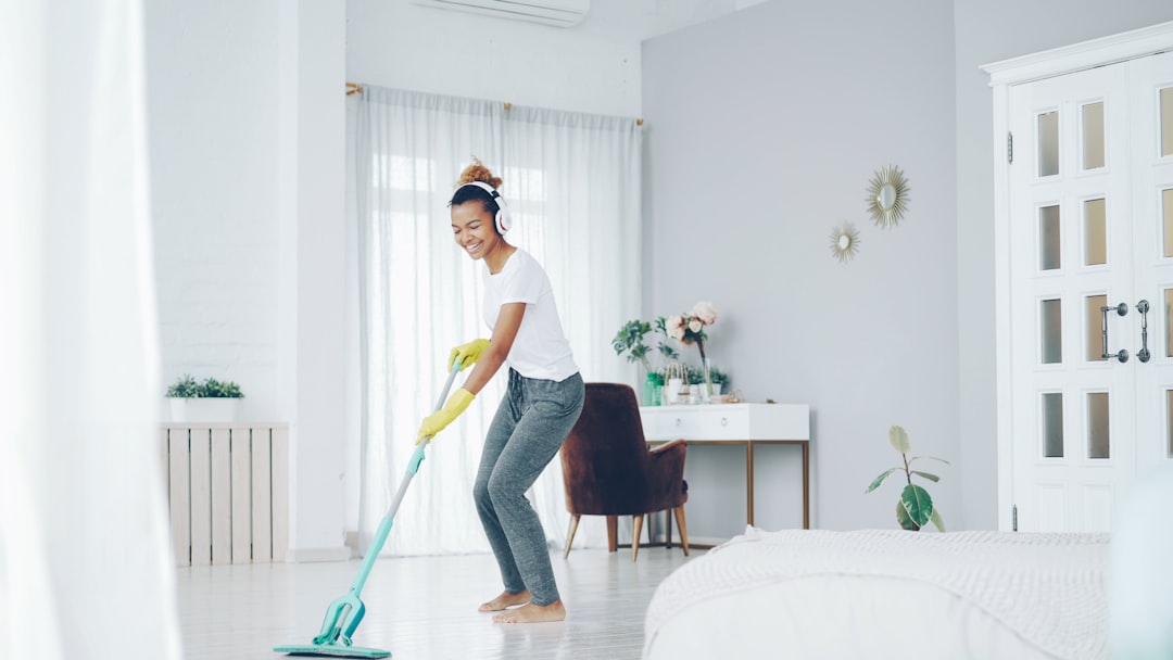 A person wiping a kitchen counter.