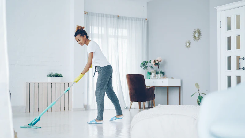 Woman mopping a living room floor