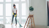 Woman mopping floor while listening to music.