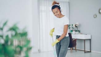 Woman with headphones cleaning floor with mop