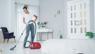 Woman dancing while vacuuming in a bright room