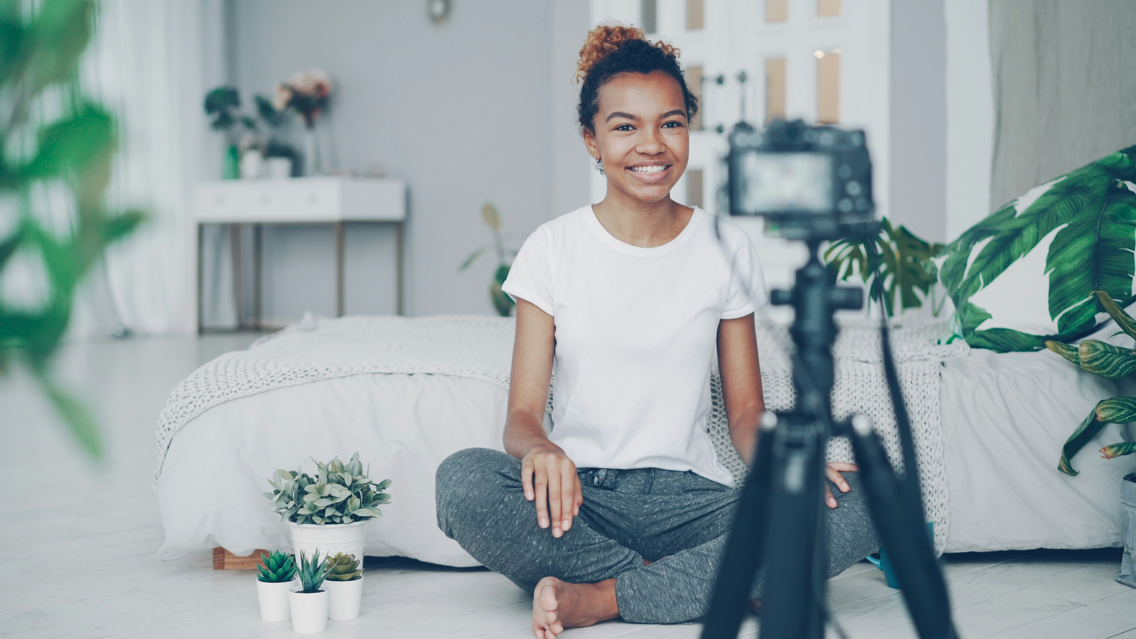 Young woman filming herself with a camera