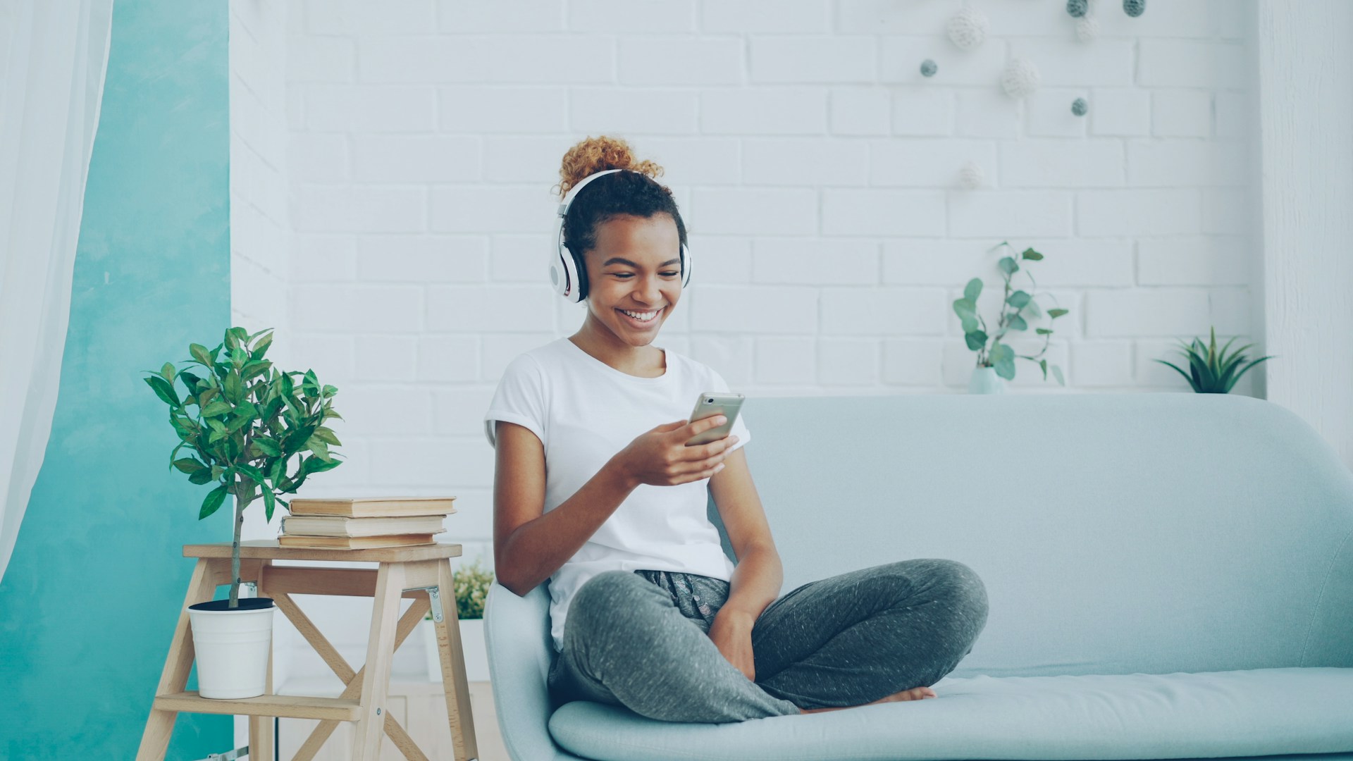 Young woman listening to music on couch