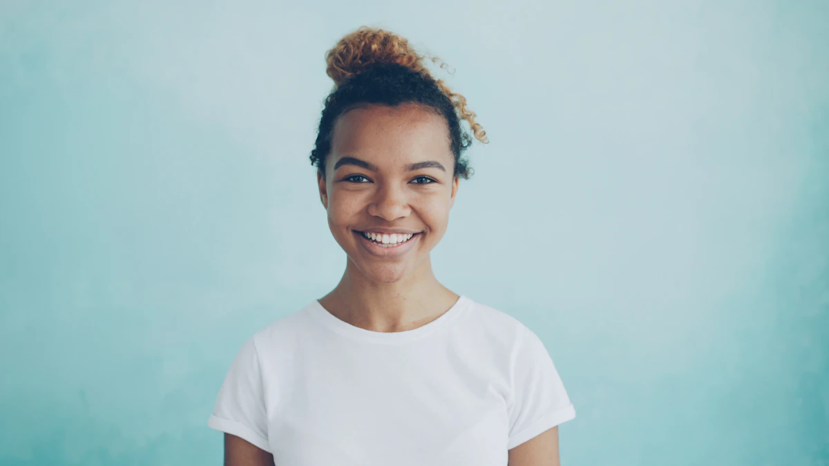İllüstratif görsel: Young woman with hair in bun smiles brightly.