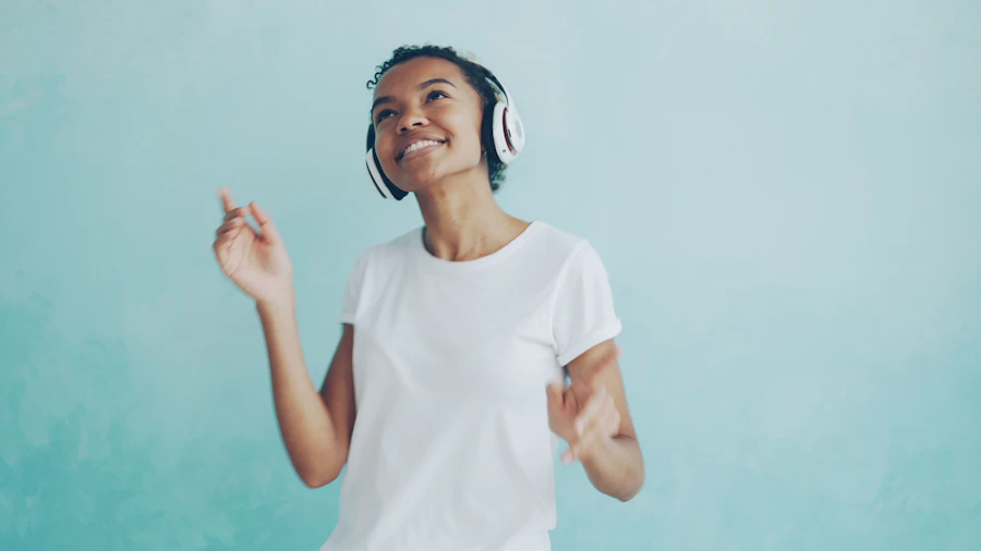 A young woman dancing to music in bright headphones