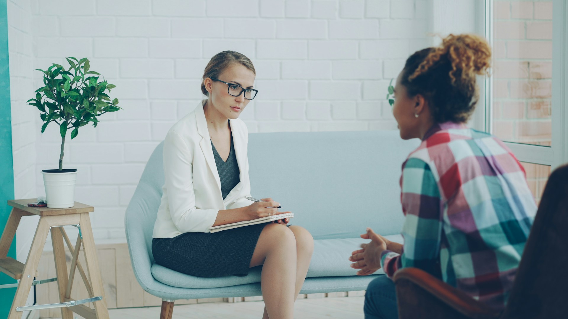 Two women talking in a therapy session