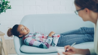 Girl lying on couch during therapy session with counsellor