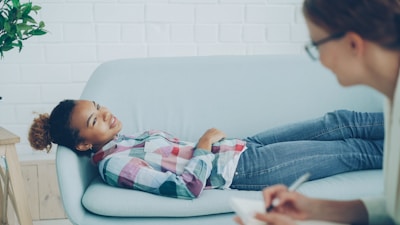 Girl lying on couch during therapy session with counsellor