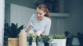 Woman watering plants on a balcony