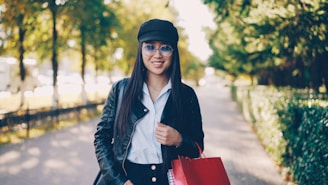 Young woman with shopping bags in park
