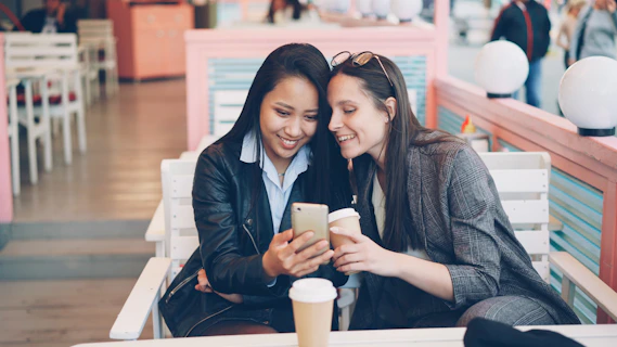 Two women looking at a smartphone together