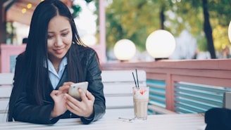 Young woman looking at phone at outdoor cafe