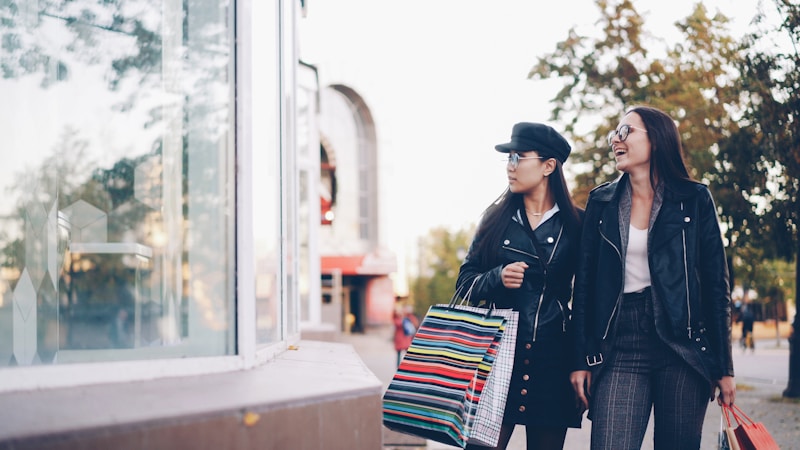 två stiliga kvinnor med shoppingväskor