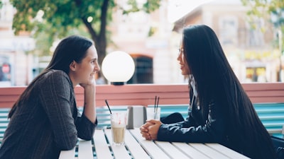 Two women chatting outdoors — dating apps Mexico City member conversation