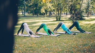 Four people practicing yoga in a park