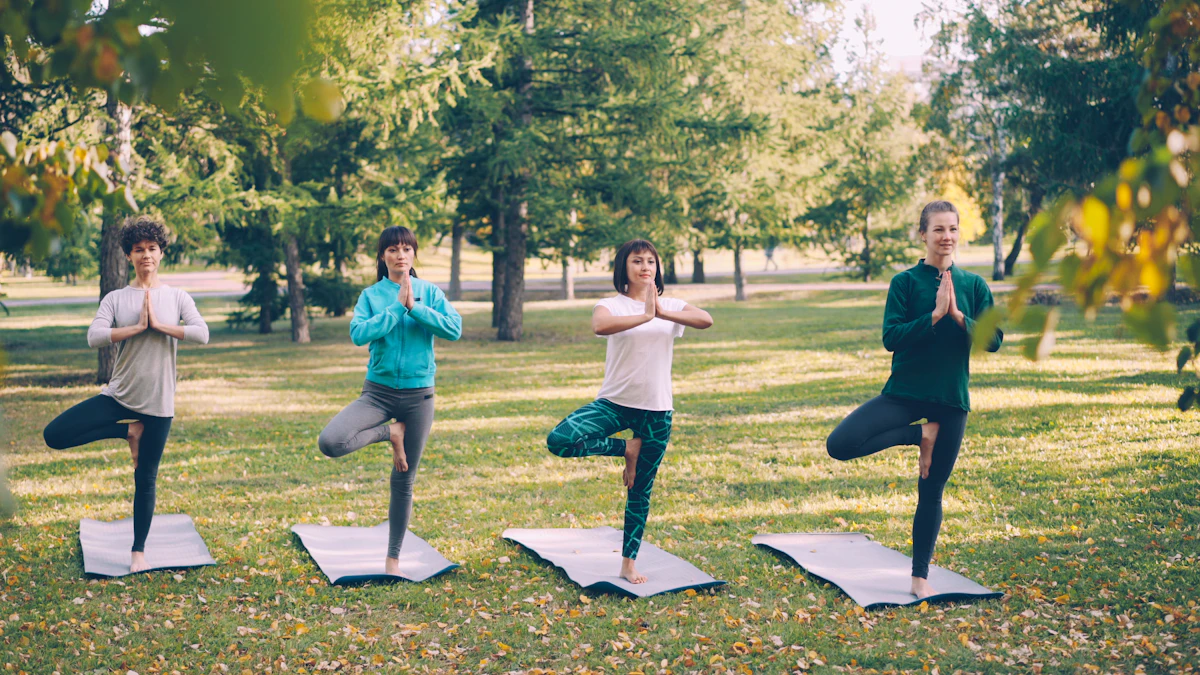 Women practicing a calm, balanced tree pose together outdoors