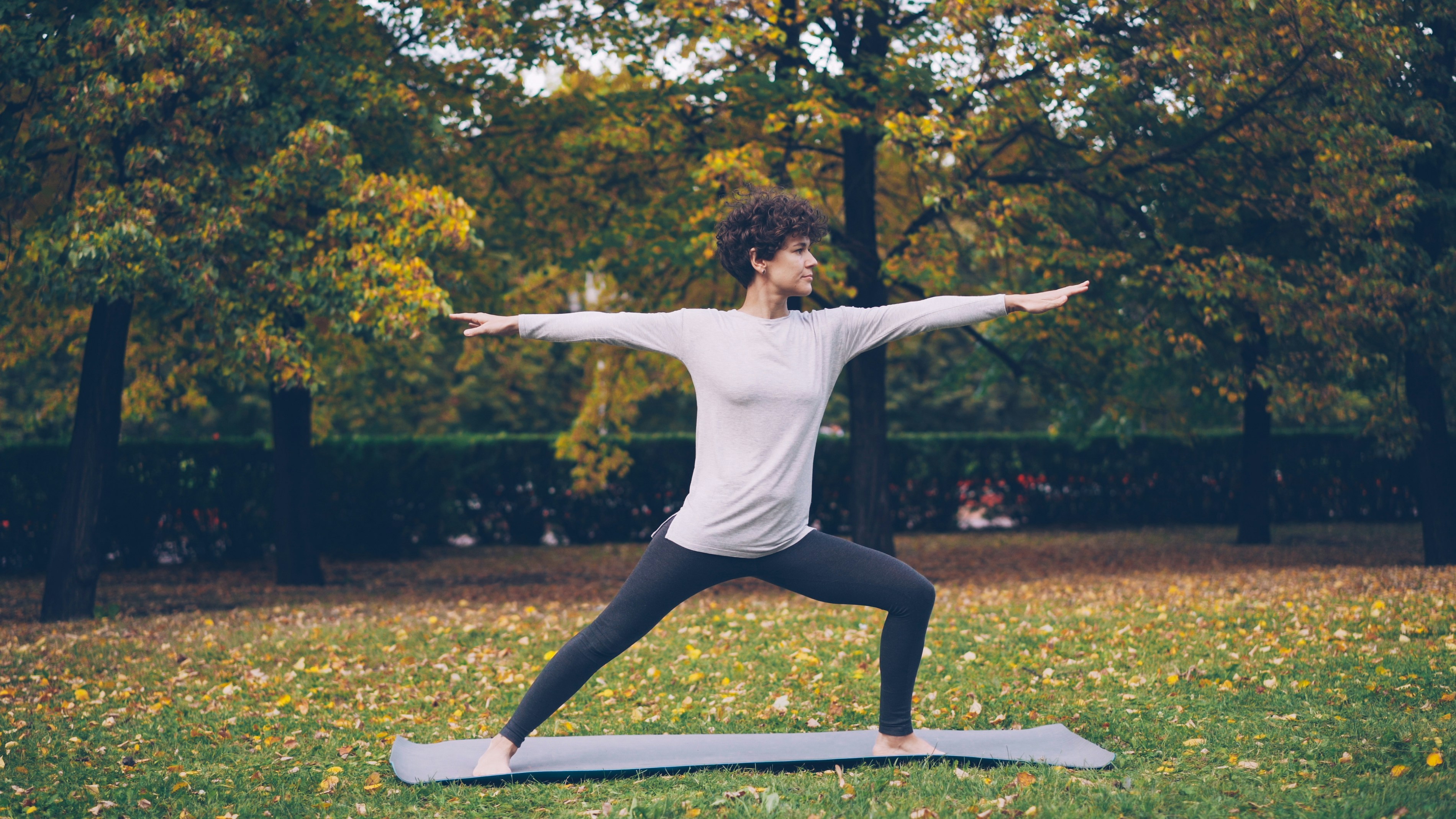 Girl with curly hair in Warrior pose