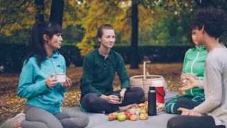 Four friends enjoying a picnic in the park.