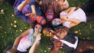 Friends with colorful powder celebrating together outdoors
