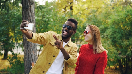 Couple taking a selfie in a park