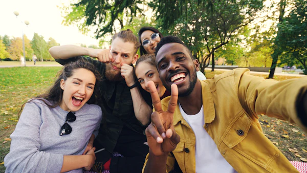 Diverse group of friends taking a selfie in a park