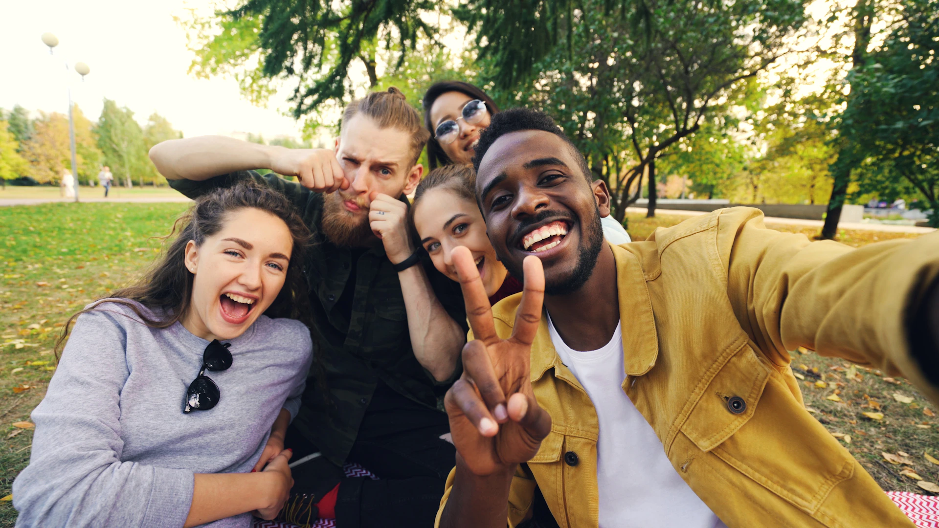 Diverse group of friends taking a selfie in park