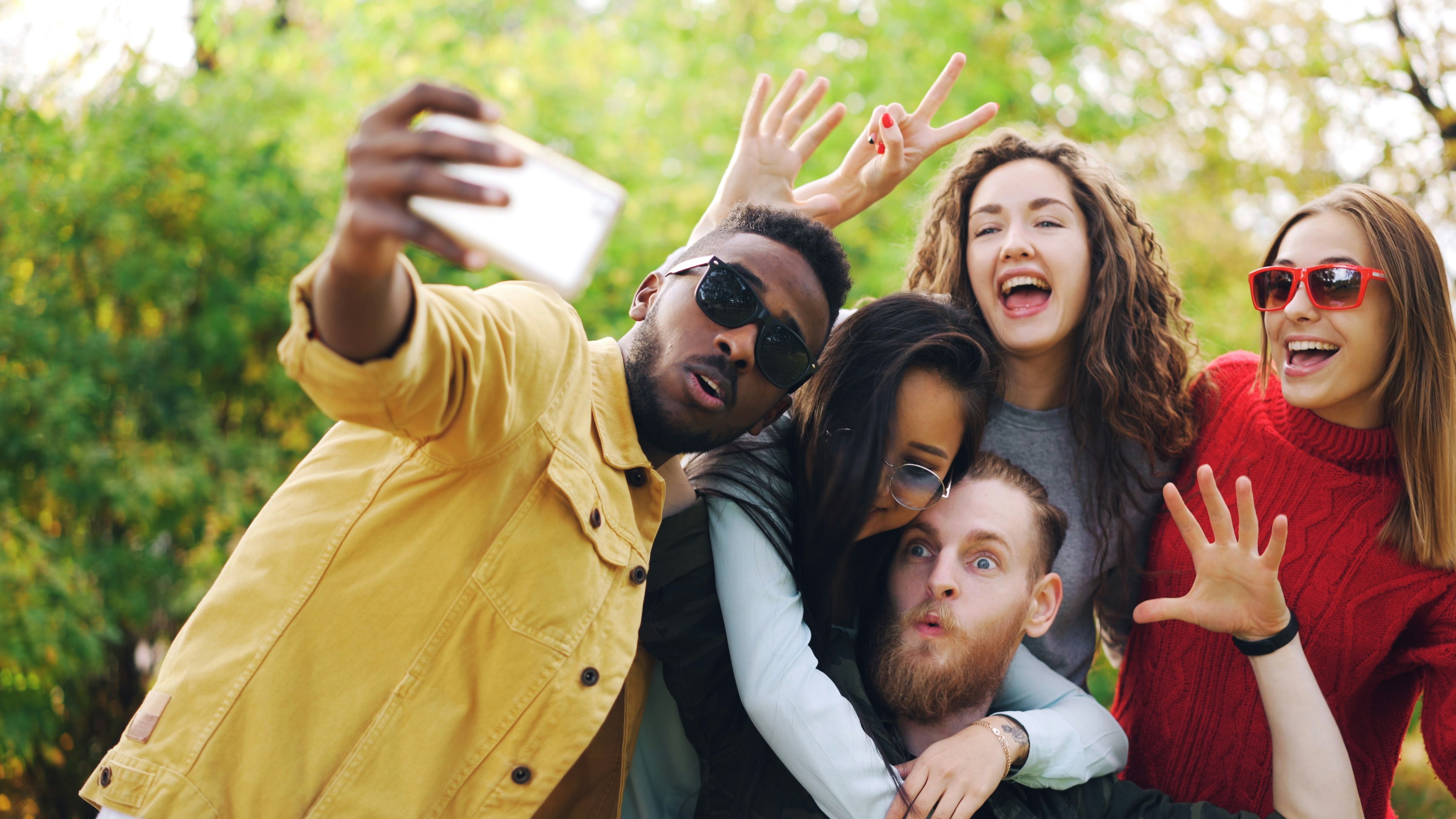 Young people taking selfie in park